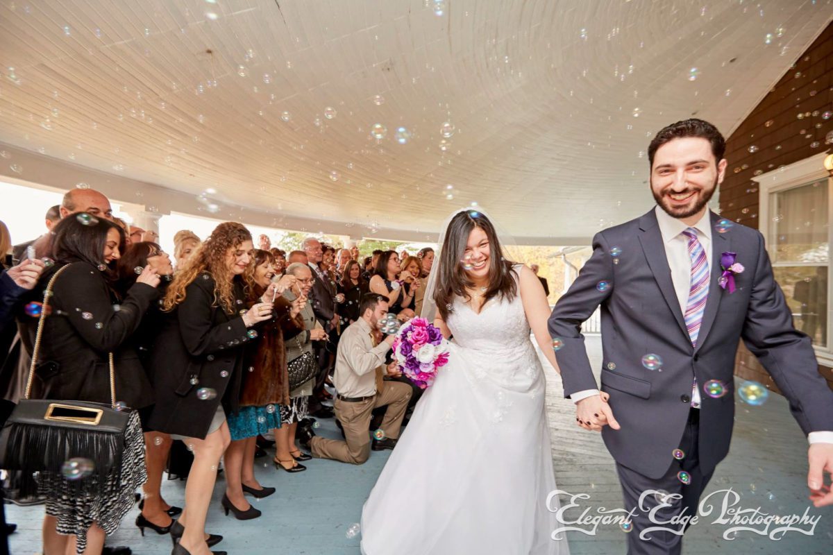 november-wedding-couple-leaving-reception-cheering-guests