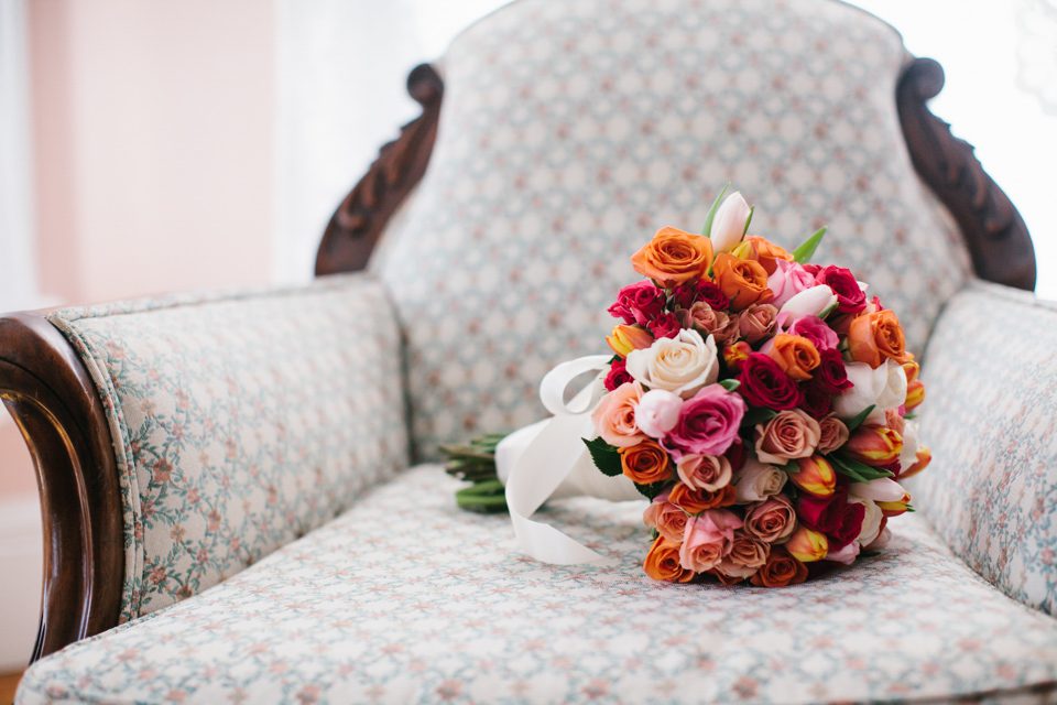 brightly colored bridal bouquet on antique chair