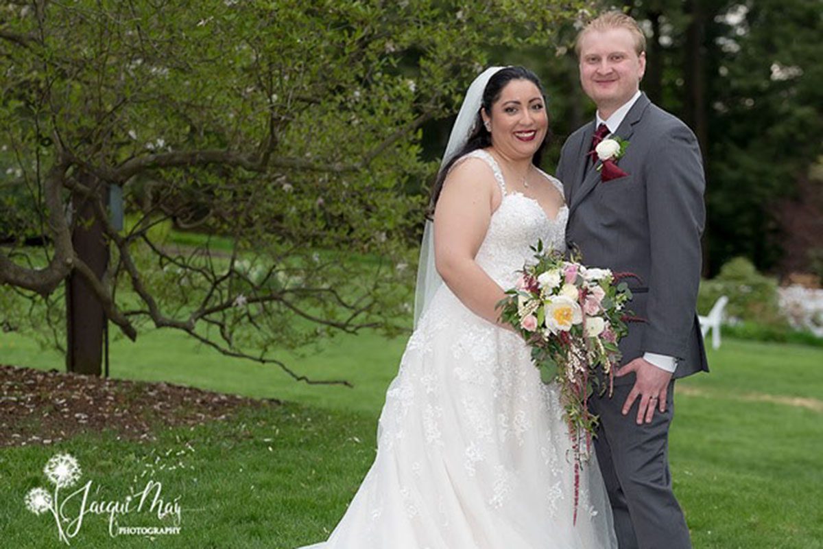 may-wedding-couple-standing-together-on-lawn