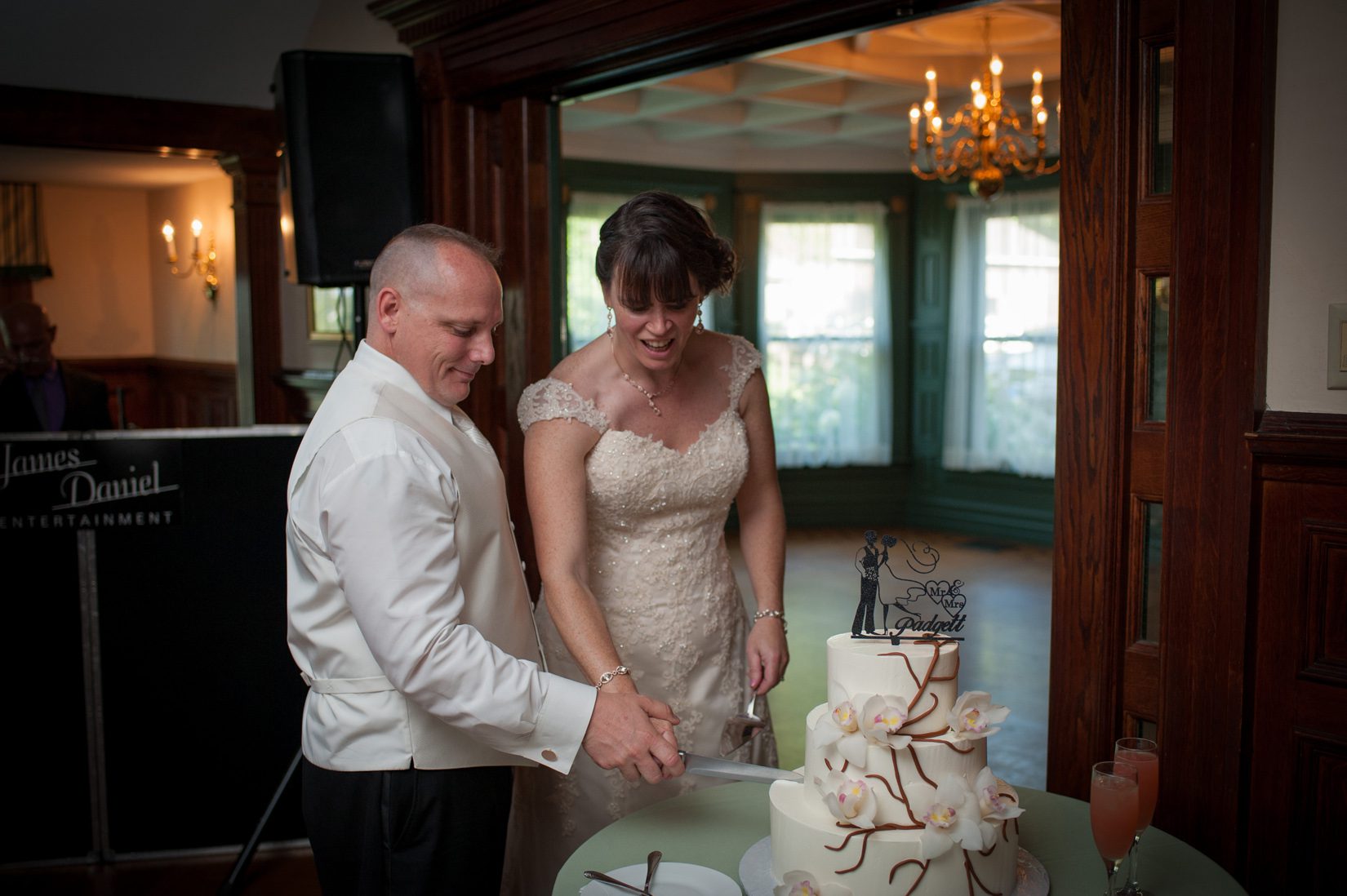 couple cutting three tier cake