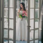 courtney in dress and flowers on lilly pond porch