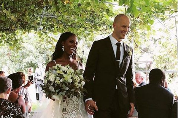 bride and groom walking down grape arbor aisle