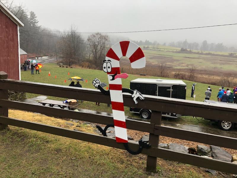 fence by red barn with funning candy cane poster