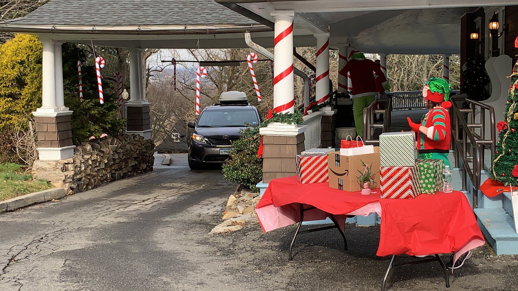 car driving up to get gift from elf